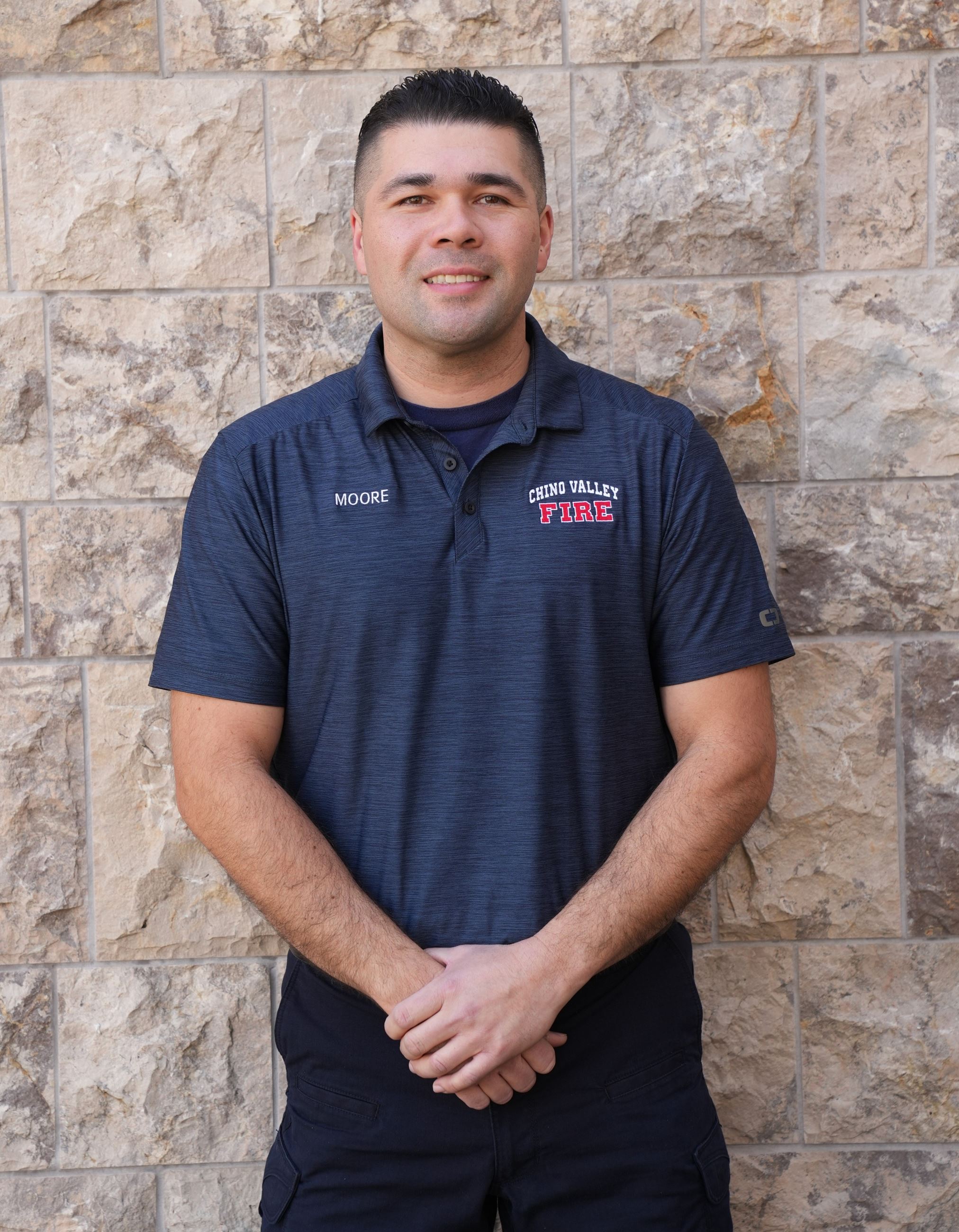 Support Services Technician Ryan Moore poses in front of wall