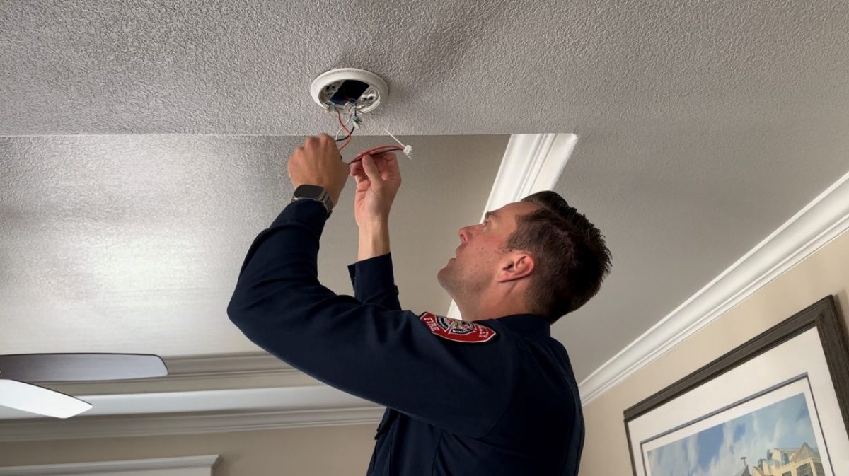 Chino Valley Firefighter installing a Smoke Alarm at a 55+ Community Home